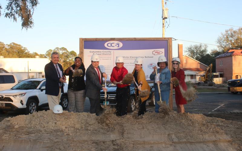 Columbia County Superintendent Lex Carswell (from left), Fort White Elementary Principal Syreeta Jackson-Lee, and school board members Hunter Peeler, Keith Hudson, Dana Brady-Giddens, Narrie Smith, and Cherie Hill take part in the ceremonial groundbreaking at Fort White Elementary Tuesday. (TONY BRITT/Lake City Reporter)