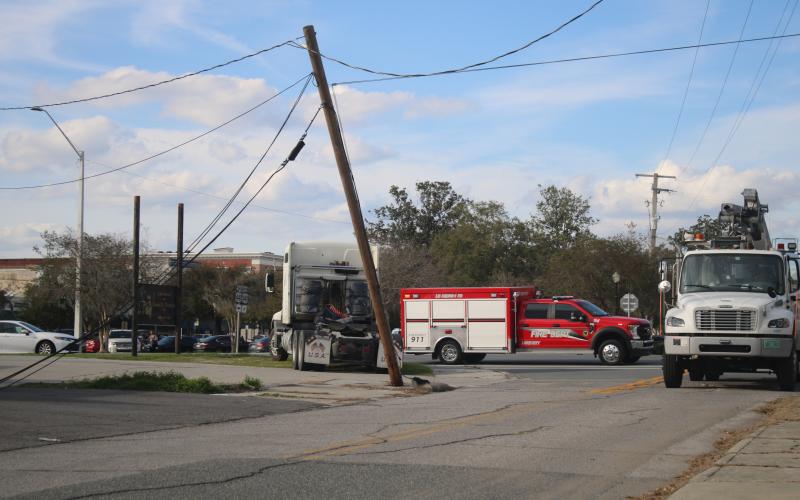 A power pole near the intersection of Duval Street and Hernando Avenue was snapped near its base Thursday afternoon after a semi truck backed into it. (TONY BRITT/Lake City Reporter)