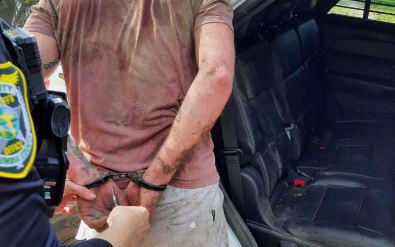 Brian Stalnaker is led away in handcuffs Wednesday after a day on the run from law enforcement. (COURTESY CCSO)