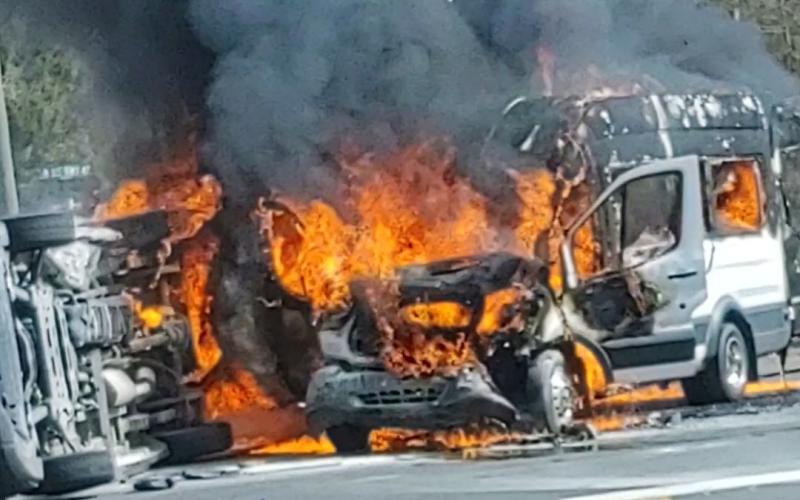 Two vans burst into flames after colliding on U.S. Highway 41 North at the intersection with NW Moore Road on Wednesday afternoon. (COURTESY)