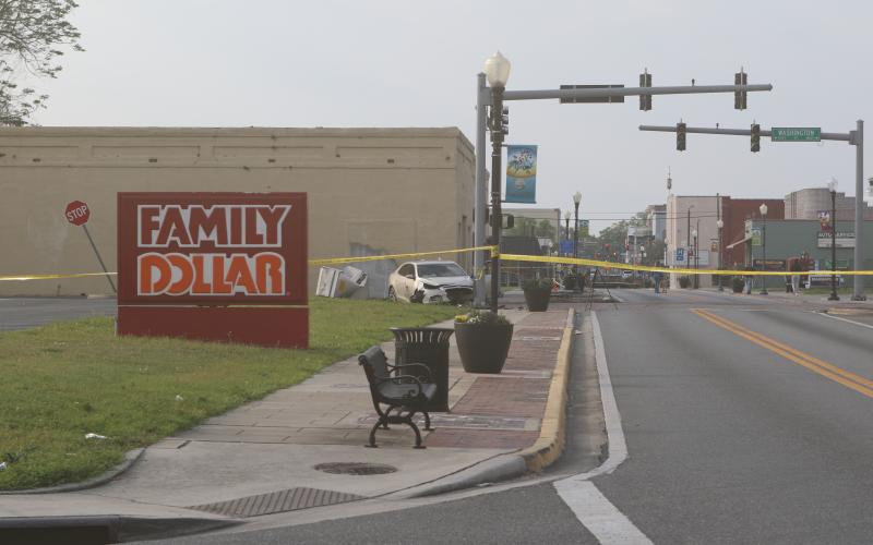 A car crashed through a traffic signal control box before slamming into the traffic signal early Friday morning. A passenger was seriously injured and the roadway was closed for hours. (JAMIE WACHTER/Lake City Reporter)