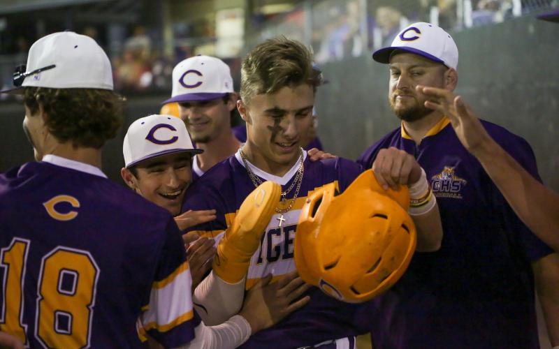 Columbia outfielder Camdon Frier is congratulated by teammates after scoring a run against Valdosta on March 16. (BRENT KUYKENDALL/Lake City Reporter)