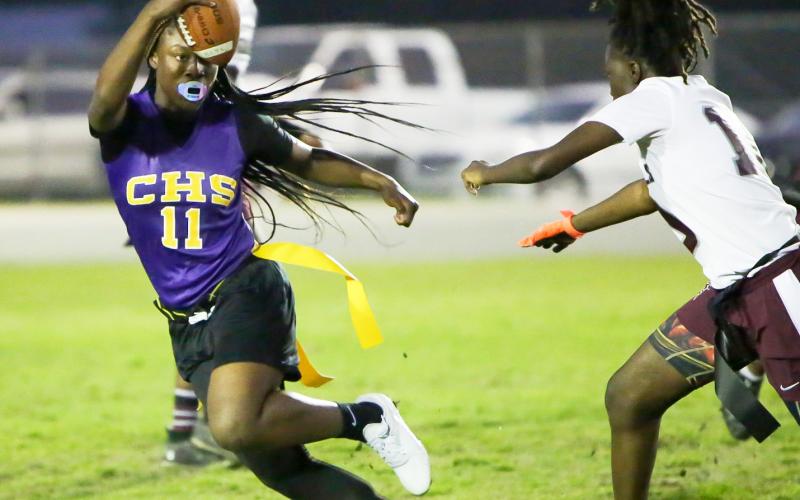 Columbia quarterback Eriel Baker scrambles away from defensive pressure against Madison County on Tuesday night. (BRENT KUYKENDALL/Lake City Reporter)
