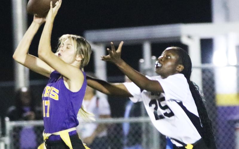Columbia safety Mia Brasel intercepts her third pass of the night in front of Baker County receiver Samuriah Major on Thursday night. (JORDAN KROEGER/Lake City Reporter)