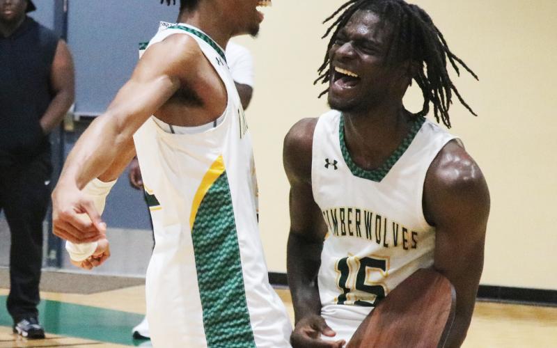 FGC guards Jeremy Young (left) and Maurice Campbell (right) celebrate after defeating Pitt CC in the South Atlantic District B championship on Saturday. (JORDAN KROEGER/Lake City Reporter)