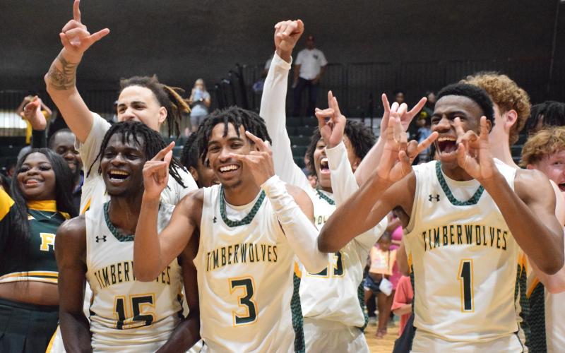 FGC players Maurice Campbell (15), Jeremy Young (3) and Jeremiah Barze (1) celebrate after defeating Palm Beach State to win the Region 8 title on Saturday. (COURTESY OF FGC)