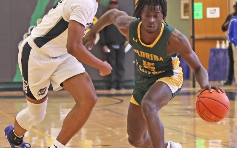 FGC guard Maurice Campbell dribbles while being defended by Davidson-Davie guard Jonathan Foust during the first round of the NJCAA tournament on Tuesday. (COURTESY OF NJCAA)