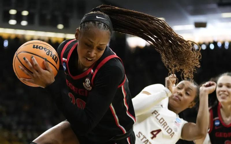 Georgia forward Jordan Isaacs grabs a rebound in front of Florida State guard Sara Bejedi during a first-round game in the NCAA tournament on Friday in Iowa City, Iowa. (CHARLIE NEIBERGALL/Associated Press)