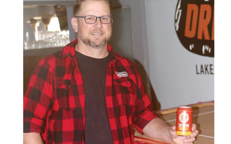 Chris Candler, co-owner of Halpatter Brewing Company, holds one of the cans of Seymour Finnegan’s, the brewery’s first cans set for distribution. (JAMIE WACHTER/Lake City Reporter)