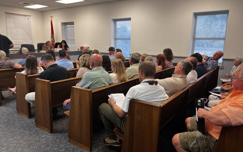The Lafayette County Commission meeting room was packed Tuesday night for a discussion about a special exception for a travel trailer park. (JAMIE WACHTER/Lake City Reporter)