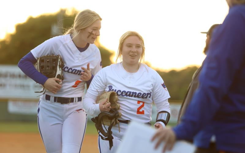 Branford's Madyson Sikes and Laila Arnold walk off the field after defeating Suwannee on Tuesday night. (PAUL BUCHANAN/Special to the Reporter)
