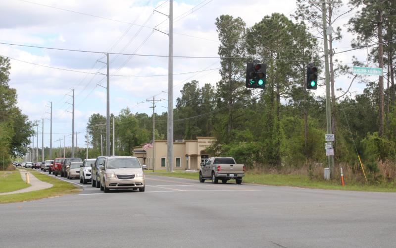 Cars sit at the intersection of Sisters Welcome Road and Bascom Norris Drive on Friday. (TONY BRITT/Lake City Reporter)