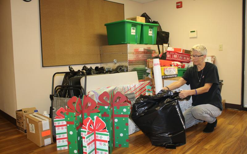 Toys for Tots coordinator Inga Dwyer packs up supplies ahead of the organization’s move out of Lake Shore Hospital property. (TONY BRITT/Lake City Reporter)