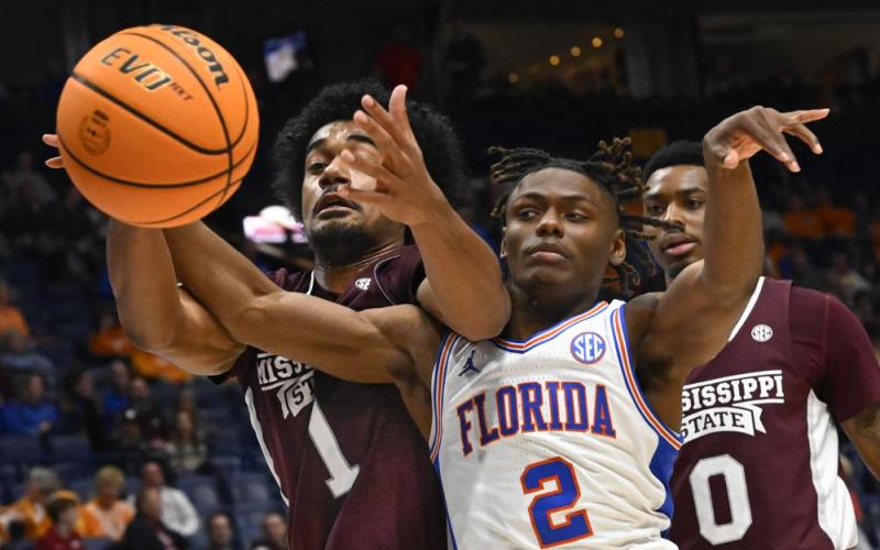 Mississippi State forward Tolu Smith and Florida guard Trey Bonham battle for the ball during Thursday's game of the SEC tournament in Nashville, Tenn. (JOHN AMIS/Associated Press)