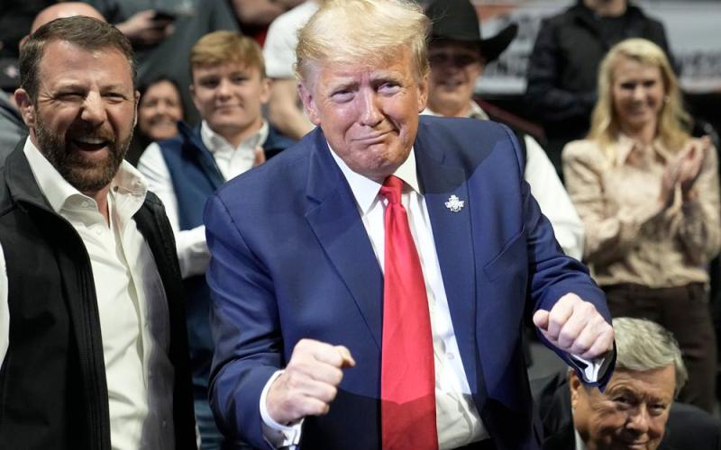 Former President Donald J. Trump gestures at the NCAA Wrestling Championships, Saturday, March 18, 2023, in Tulsa, Okla. (SUE OGROCKI/Associated Press)