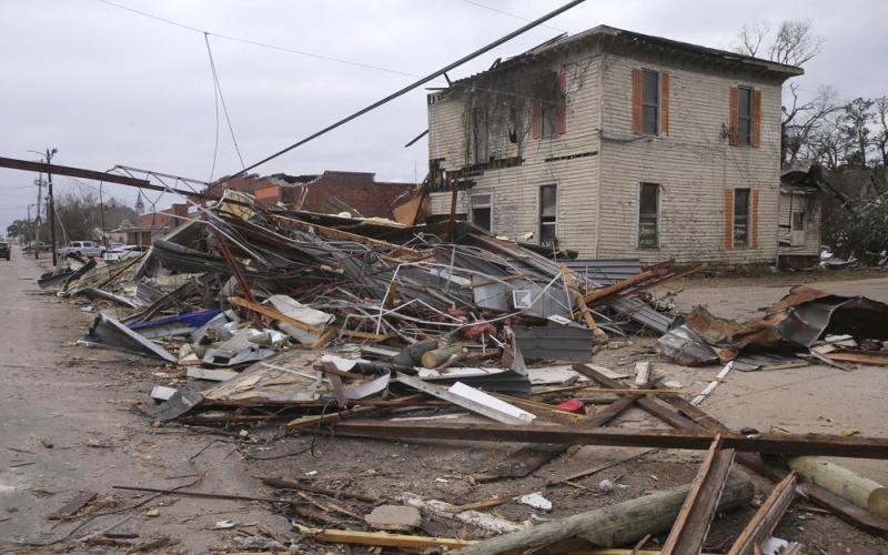 Debris from local businesses covers the street in Selma, Ala., on Jan. 13 after a tornado passed through the area. After three nasty years, the La Nina weather phenomenon is gone, the National Oceanic and Atmospheric Administration said Thursday. (STEW MILNE/AP file)