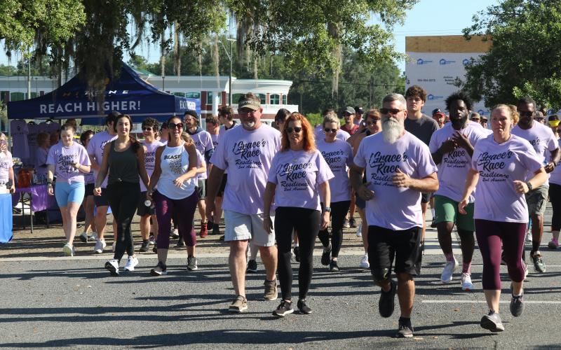 Grace Duncan’s parents, Burt and Cissy (center) help lead the start of last year’s Grace’s Race 5K. The third annual race is scheduled for Saturday at the Heritage Oaks Circle Shopping Center. (FILE)