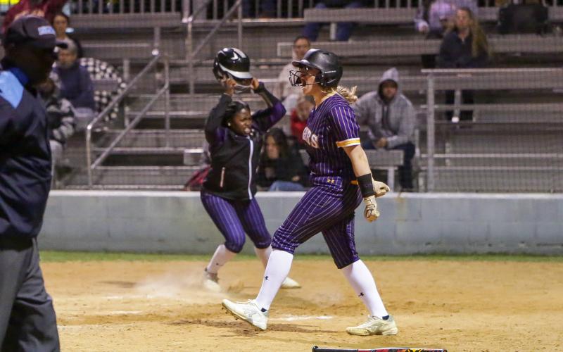 Columbia's McKenna O'Sullivan (left) and Zoryana Hughes (right) celebrate at home plate after Hughes scored the game-winning run to beat Baker County in extra innings on Monday night. (BRENT KUYKENDALL/Lake City Reporter)