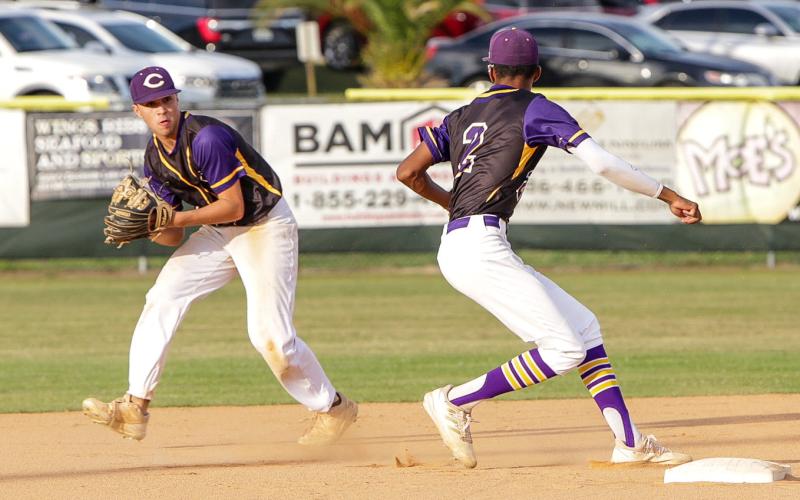 Columbia second baseman Grant Bowers sets to flip the ball to shortstop Brayden Thomas for an out against Union County on April 19. (BRENT KUYKENDALL/Lake City Reporter)