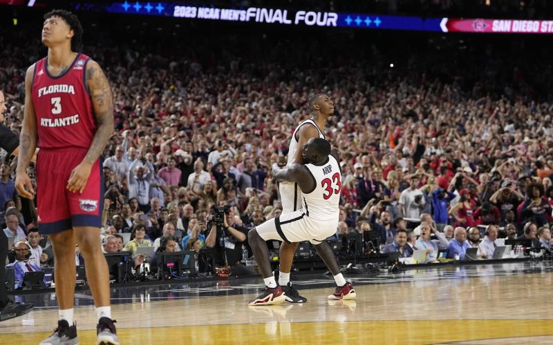San Diego State guard Lamont Butler celebrates after scoring the game-winning basket with forward Aguek Arop (33) during the Final Four against Florida Atlantic on Saturday in Houston. (DAVID J. PHILLIP/Associated Press)