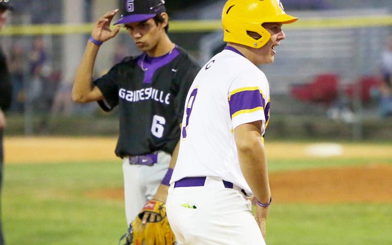 Columbia’s Waylon Fulford celebrates on third base after hitting an RBI triple against Gainesville on Friday night. It was Fulford’s first career hit. (BRENT KUYKENDALL/Lake City Reporter)