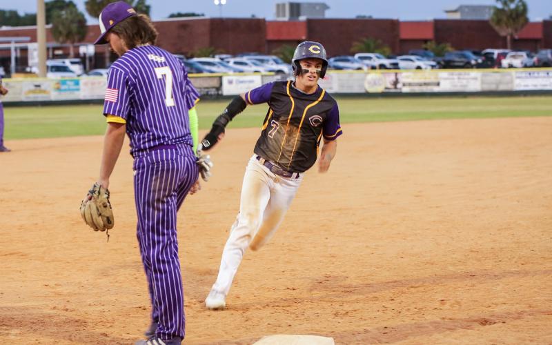 Columbia’s Hayden Gustavson turns off third base to head home for a run against Union County on Wednesday night. (BRENT KUYKENDALL/Lake City Reporter)