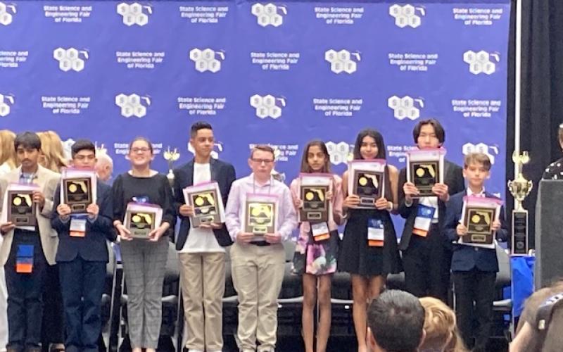 Fort White Middle School’s Cyler Robinson (center) receives his first-place recognition at the State Science and Engineering Fair of Florida in Lakeland on April 4-6. (COURTESY)