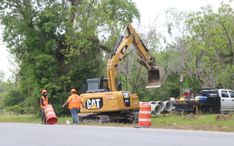 A crew with Anderson Columbia sets up barricades along the side of State Road 47 on Monday as work began on a widening and resurfacing project. (TONY BRITT/Lake City Reporter)