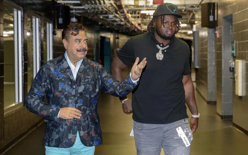 Jacksonville Jaguars owner Shad Khan walks first-round draft pick offensive lineman Anton Harrison (right) to a news conference on Friday in Jacksonville. (GARY MCCULLOUGH/Associated Press)