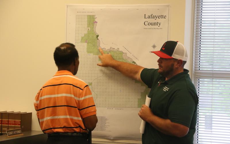 Lafayette County Building/Zoning Director Garrett Land (right) looks at the county’s future plan use map with Commission Chairman Earnest Jones during a workshop Tuesday on RV sites. (MORGAN MCMULLEN/Lake City Reporter)