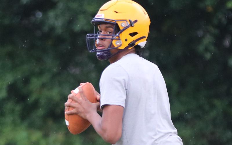 Columbia quarterbacks Zack Paulk drops back to pass during Monday’s practice. (JORDAN KROEGER/Lake City Reporter)
