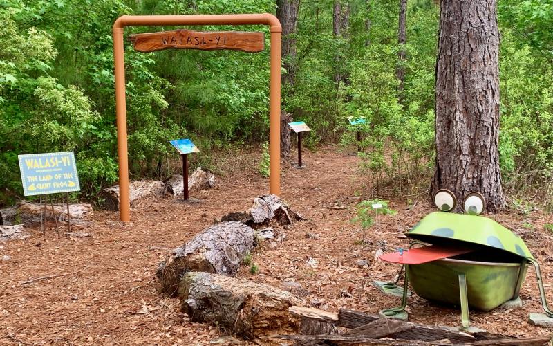 The entrance to the story walk at Hearthstone Gardens includes a frog statue and a sign that reads, ‘Walasi-yi,’ which means ‘Land of the great frog.’ The story walk includes stories about frogs. (COURTESY)