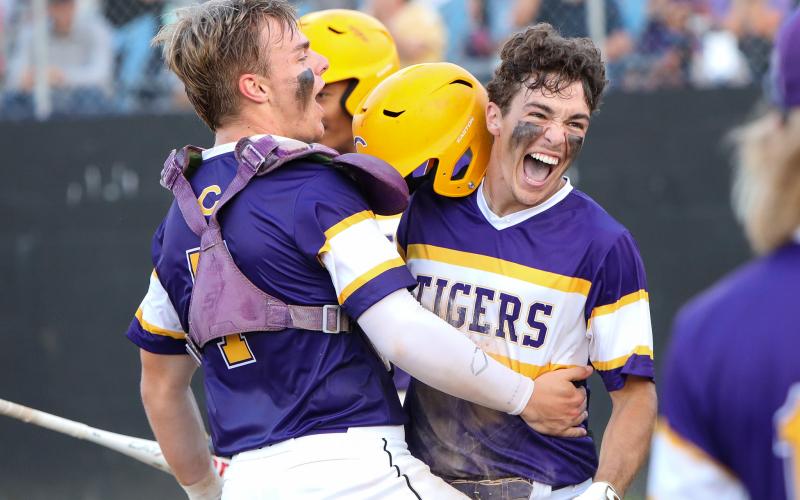 Columbia outfielder Carston Palmer (right) celebrates with catcher Hayden Gustavson after scoring a run against Pine Forest during the Region 1-5A quarterfinals on Tuesday night. (BRENT KUYKENDALL/Lake City Reporter)