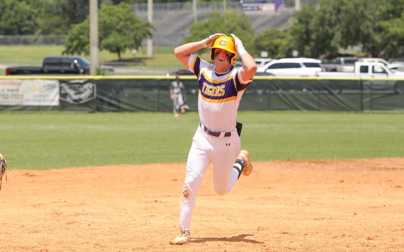 Columbia first baseman Josh Fernald celebrates rounding third base after hitting a walk-off grand slam against Lincoln on Saturday in the Region 1-5A semifinals. (BRENT KUYKENDALL/Lake City Reporter)