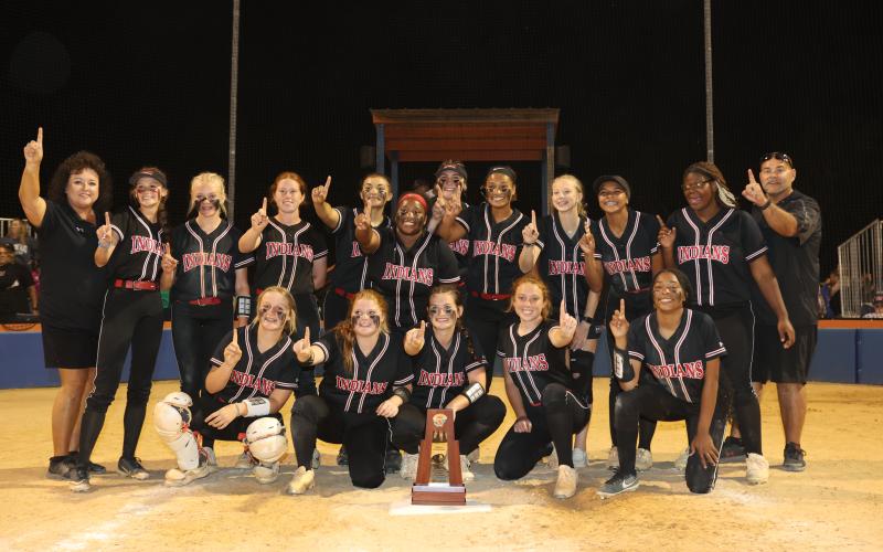 Fort White celebrates with the District 6-1A championship trophy after defeating Branford 7-0 on Thursday night. (PAUL BUCHANAN/Special to the Reporter)