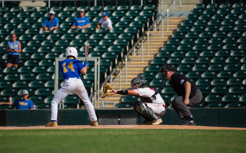 Lafayette catcher Hunter Vann catches a pitch while Chipley second baseman Lawson Corbitt bats during the Class 1A state championship Thursday at Hammond Stadium in Fort Myers. (JESSICA PINALD/Special to the Reporter)