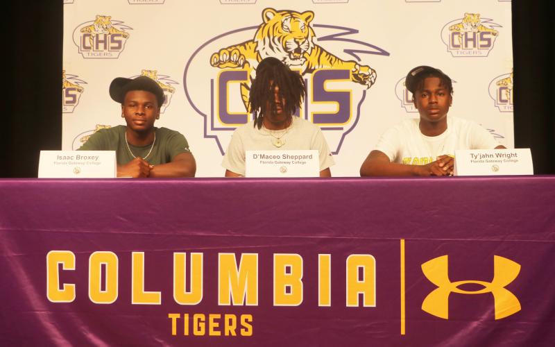 Columbia basketball players Isaac Broxey (from left), D’Maceo Sheppard and Ty’jahn Wright signed letters of intent to play at Florida Gateway College on Wednesday. (JORDAN KROEGER/Lake City Reporter)