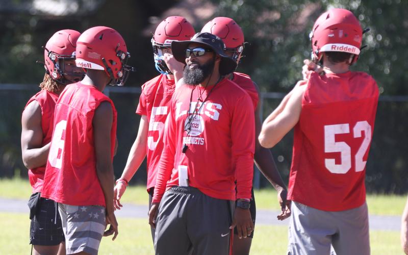 Lafayette head coach Marcus Edwards speaks with quarterback Tywan Williamson during practice on May 3. (MORGAN MCMULLEN/Lake City Reporter)