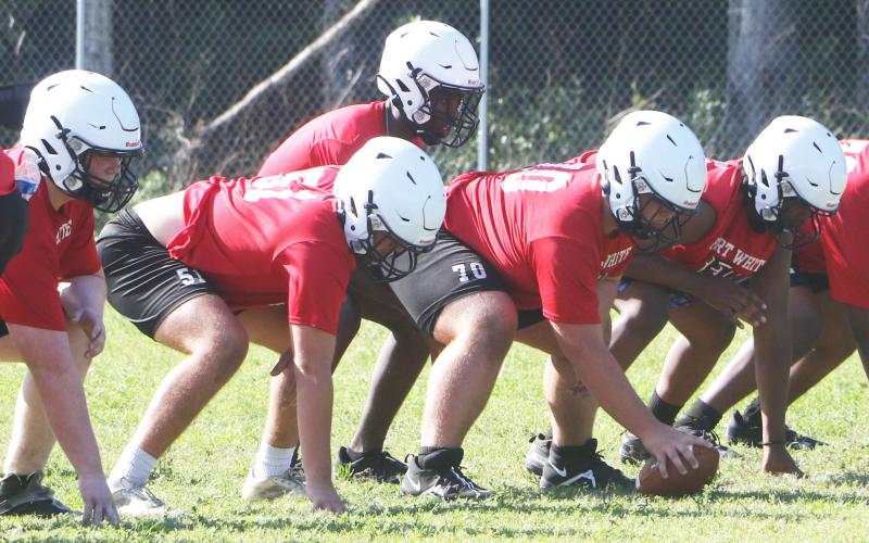 Fort White quarterback Jayden Jackson gets set to take a snap during practice on May 1. (MORGAN MCMULLEN/Lake City Reporter)