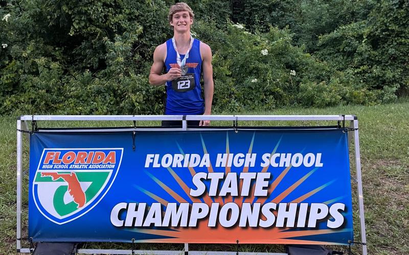 Branford’s Cash Blalock is pictured with his seventh-place medal in the high jump at the Class 1A state meet on Wednesday at Hodges Stadium in Jacksonville. (COURTESY)