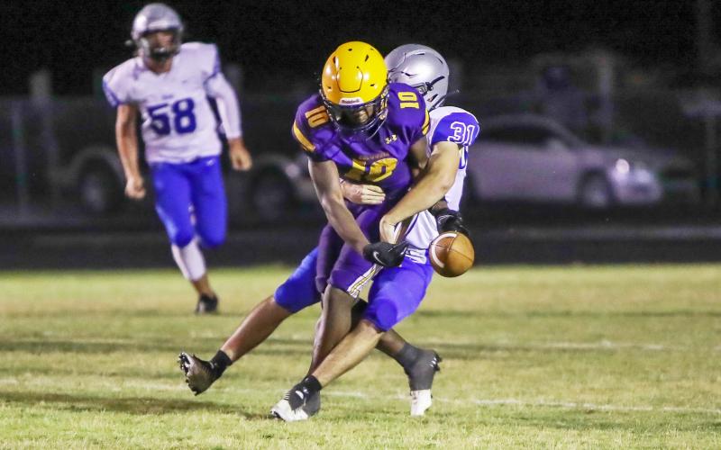 Columbia receiver Zamarion Jones is stripped by Bartram Trail linebacker Josiah Smith during Friday’s spring game. (BRENT KUYKENDALL/Lake City Reporter)