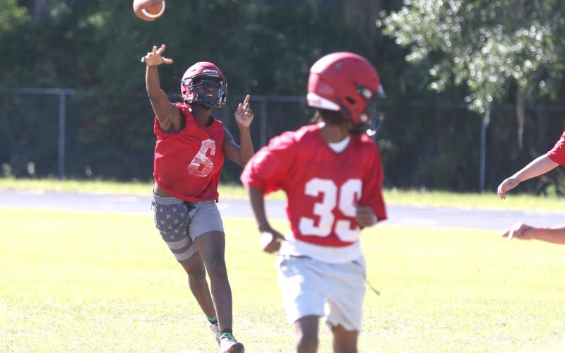 Lafayette quarterback Tywan Williamson tosses a pass during a rollout on the third day of the Hornets’ spring practices on Wednesday. Williamson, a rising sophomore, will be trusted with more of the playbook this upcoming season, according to head coach Marcus Edwards. (MORGAN MCMULLEN/Lake City Reporter)