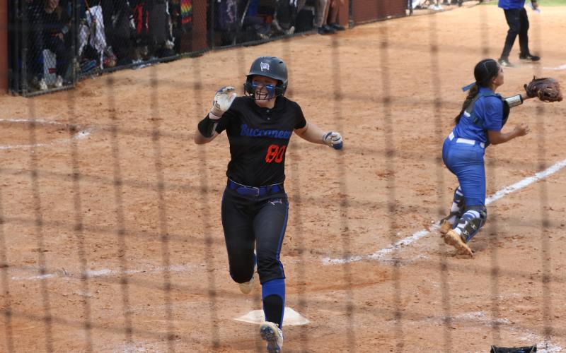 Branford catcher Morgan Brennan smiles as she scores the first run of the 1A state semifinals game against defending champion Jay Monday at Legends Ballfield. (MORGAN MCMULLEN/Lake City Reporter)