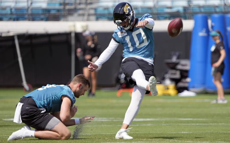Jacksonville Jaguars kicker Brandon McManus (10) works on field goals as Logan Cooke holds during practice on Tuesday in Jacksonville. (JOHN RAOUX/Associated Press)