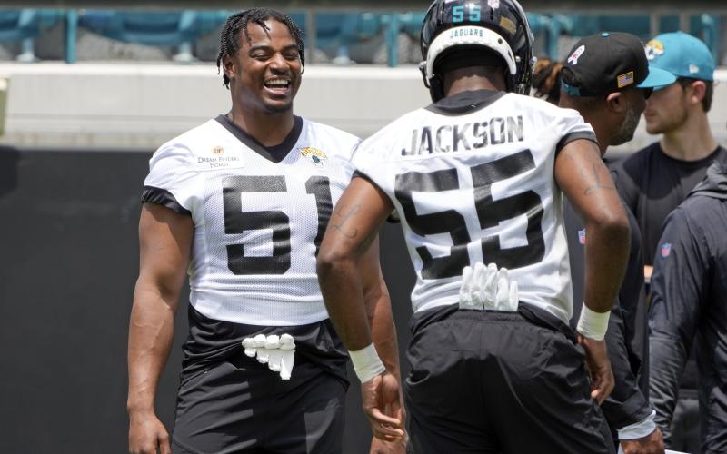 Jacksonville Jaguars linebacker Ventrell Miller (51) shares a laugh with linebacker Dequan Jackson (55) during the team's rookie camp on Friday in Jacksonville. (JOHN RAOUX/Associated Press)