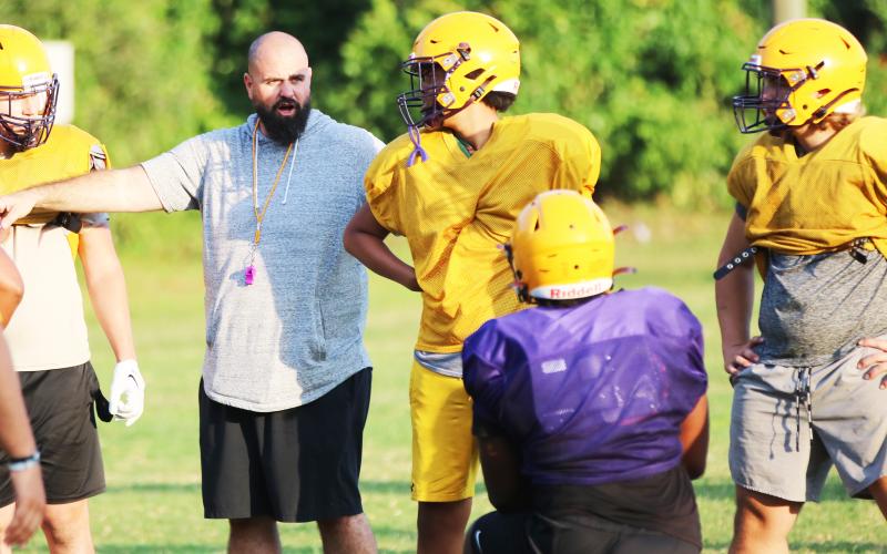 Columbia offensive line coach John Woodley works with the offensive line during Monday’s practice. (JORDAN KROEGER/Lake City Reporter)
