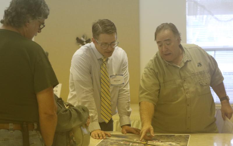 Tim Liguori (right) talks with Florida Department of Transporation’s Nick Hope about the state’s plans for the State Road 247 and County Road 240 intersection during an open house Thursday. (JAMIE WACHTER/Lake City Reporter)