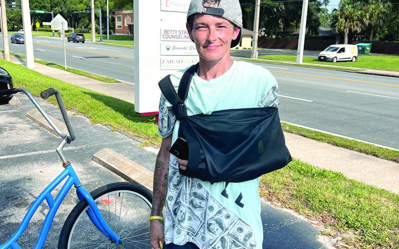 Brandy Dent is pictured at the Oak Bridge office building Friday, two days after she said she helped stop a car from backing over a child. (JAMIE WACHTER/Lake City Reporter)