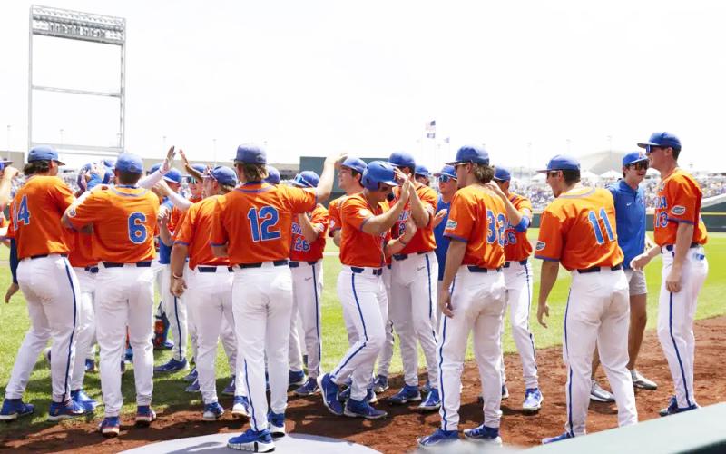Florida players celebrate after Josh Rivera batted in Wyatt Langford (center) with a home run against TCU in the first inning of Wednesday's College World Series game in Omaha, Neb. (REBECCA S. GRATZ/Associated Press)