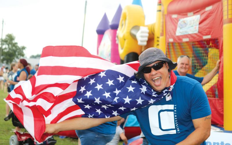 Earnest Burch waved down festival-goers with his Old Glory cape at the 2019 Independence Day event at the Columbia County Fairgrounds. After no festival a year ago, the City of Lake City and the Rotary Club of Lake City are bringing a full slate of activities to the banks of Lake DeSoto this year. (FILE)